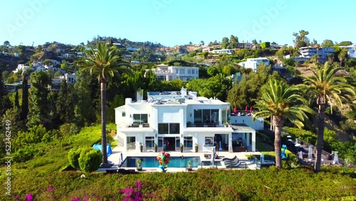 Drone flying towards luxurious mansions on Hollywood Hills in Los Angeles. Real estate prices, inflation photo