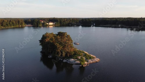 Tiny island on a lake. Fly by drone shot photo