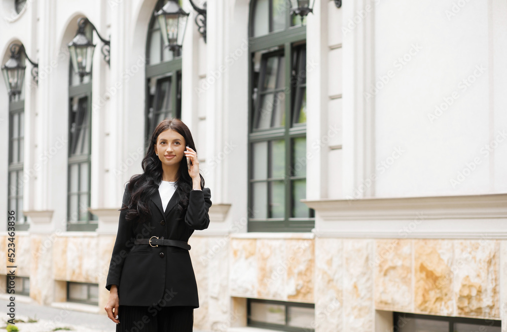 Fototapeta premium Woman Calling on Phone Portrait of Beautiful Smiling Female Talking on Phone Outdoors.