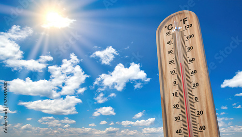 Thermometer against bright blue sky. Comfortable temperature concept.