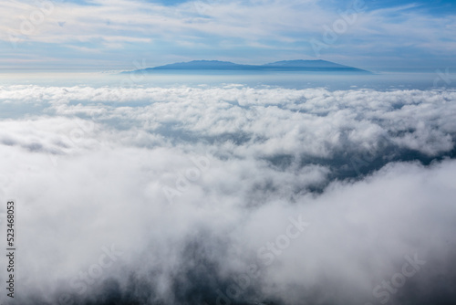 Above the clouds; a sea of clouds above the ocean in between the isle of La Gomera and the isle of la Palma in the background.