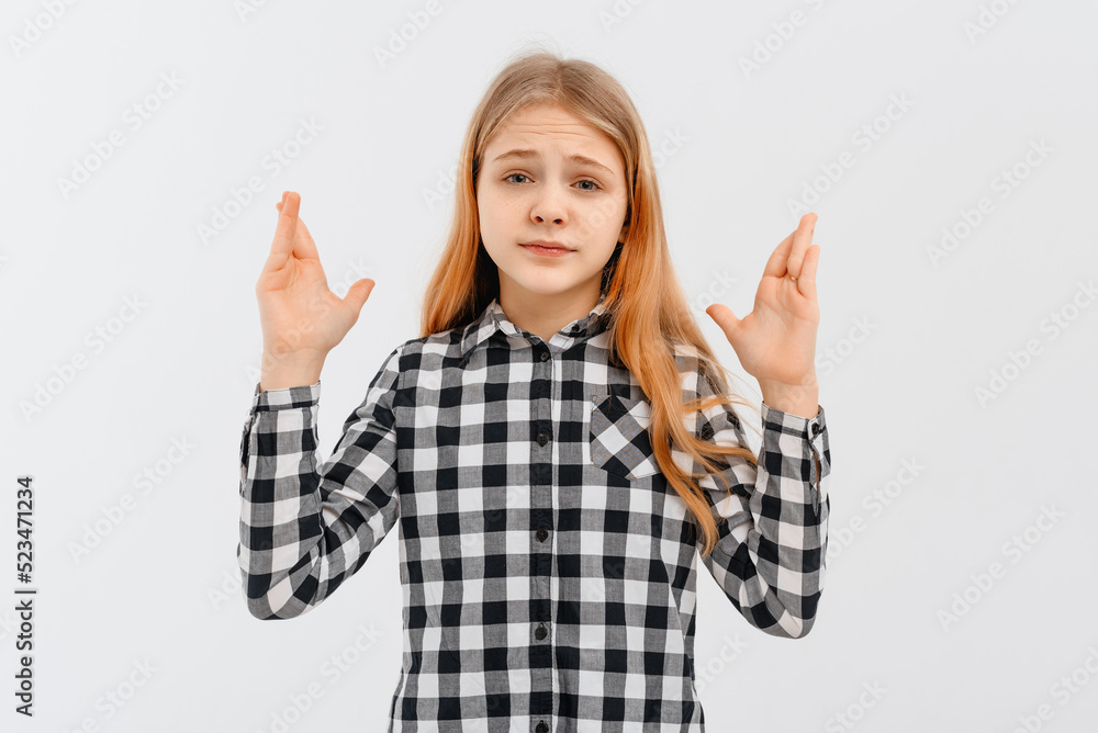 Frustrated teen girl raising hands dismay and disappointment, standing over white background in casual shirt. Indoor studio shot on white background Frustrated teen girl raising hands dismay and disappointment, standing over white background in casual shirt. Indoor studio shot on white background