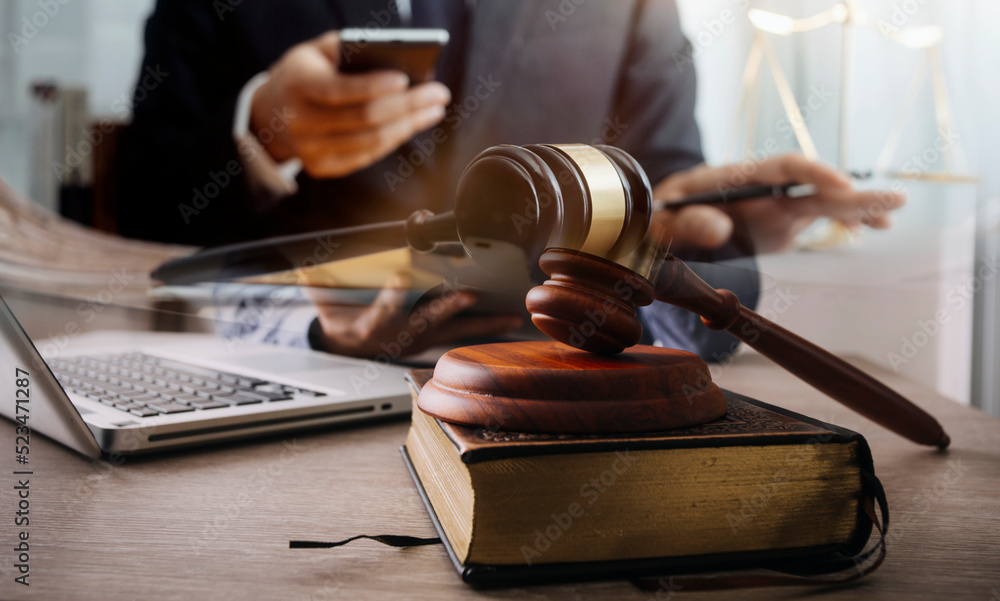 Male lawyer working with contract papers and wooden gavel on tabel in courtroom. justice and law ,attorney, court judge, concept. Male lawyer working with contract papers and wooden gavel on tabel in courtroom. justice and law ,attorney, court judge, concept.