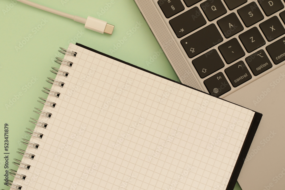 empty notebook, white usb c cable and laptop empty notebook, white usb c cable and laptop
