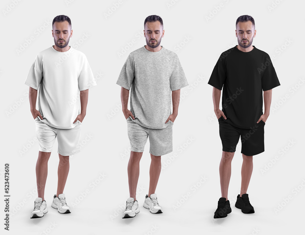 Mockup of white, black, heather oversized suit, t-shirt, shorts on brutal man in sneakers with hands in pockets, for design, advertising. Mockup of white, black, heather oversized suit, t-shirt, shorts on brutal man in sneakers with hands in pockets, for design, advertising.
