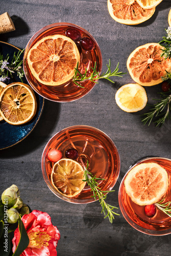 Cranberry champagne cocktails garnished with orange and rosemary