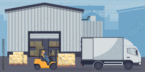 Industrial warehouse for the storage of products. Worker driving forklift loading pallets to refrigerator truck. Industrial storage and distribution of products