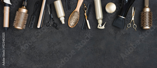 Various hair dresser tools on dark background with text space