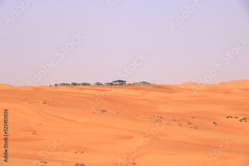 Fototapeta Naklejka Na Ścianę i Meble -  Bedouin style camping beside a huge sand dune at the Wahiba Sands desert, Oman.