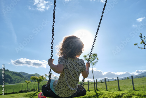 happy caucasian girl enjoying on park swing - playground
