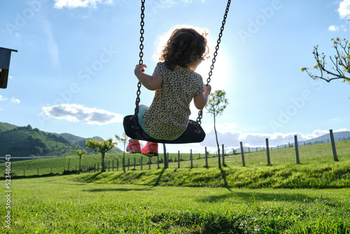 happy caucasian girl enjoying on park swing - playground