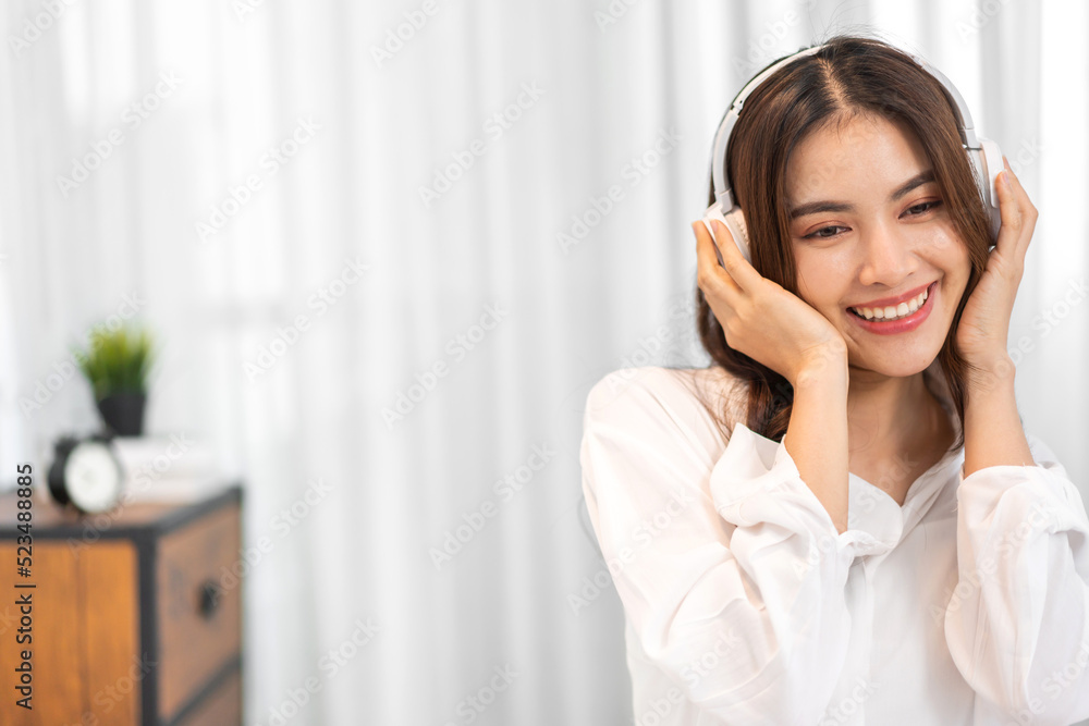 Portrait of big smiling happy beautiful pretty asian woman clean fresh healthy white skin posing smile in pajamas white clothes.Girl felling relax and enjoy time on the bed at home.asia beauty Portrait of big smiling happy beautiful pretty asian woman clean fresh healthy white skin posing smile in pajamas white clothes.Girl felling relax and enjoy time on the bed at home.asia beauty