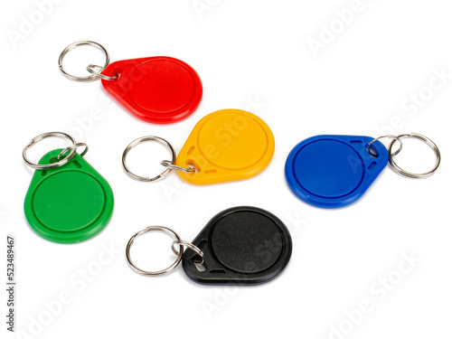 Color key fobs contactless authentication NFС and RFID on a table. Isolated on white background.