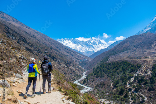 Slika na platnu A group of people trekking on dirt road in Nepal to Everest Base Camp