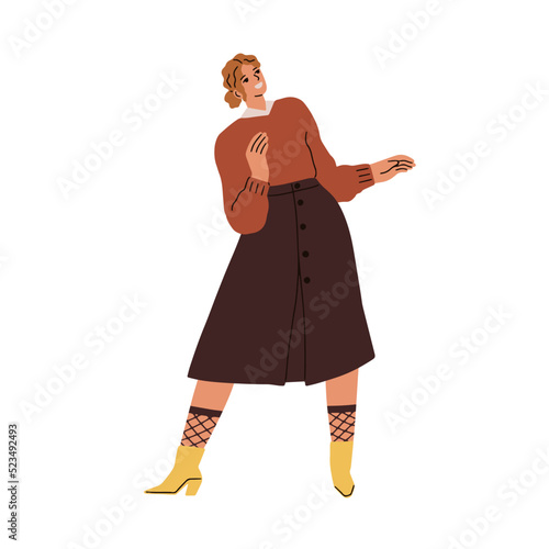 Happy woman dancing, swinging to music. Smiling young girl standing in fashio...