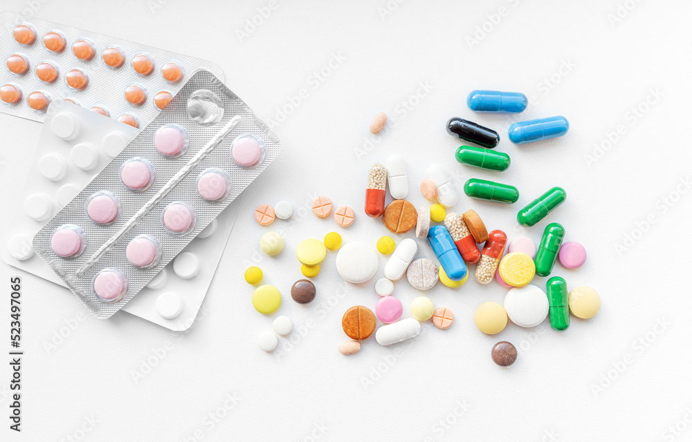 Multicolored pills on a white background. Treatment and health. Multicolored pills on a white background. Treatment and health.