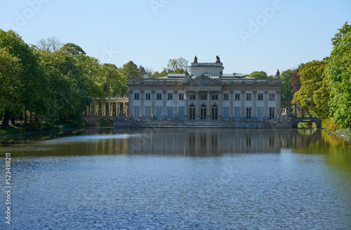 Palace on isle at lake in baths park in Warsaw city of Poland