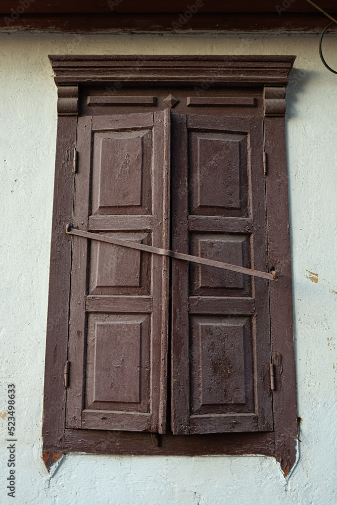 Old closed window with wooden shutters