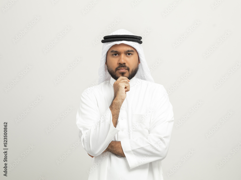 Portrait of arabic man with kandura dress on isolated white background. Arab business people thinking. Portrait of arabic man with kandura dress on isolated white background. Arab business people thinking.