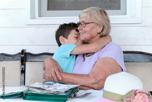 Фотография grandson hugs his grandmother at home