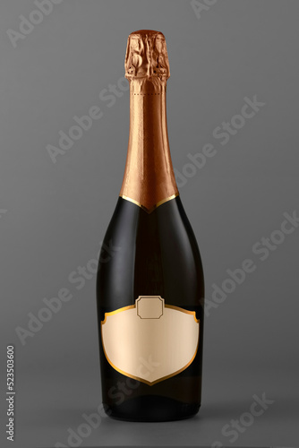 Champagne bottle isolated on gray background, close-up