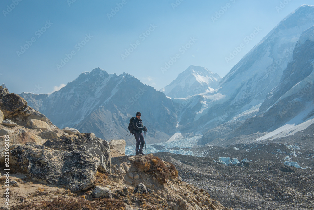 Male backpacker enjoying the view on mountain walk in Himalayas. Everest Base Camp trail route, Nepal trekking, Himalaya tourism. Male backpacker enjoying the view on mountain walk in Himalayas. Everest Base Camp trail route, Nepal trekking, Himalaya tourism.