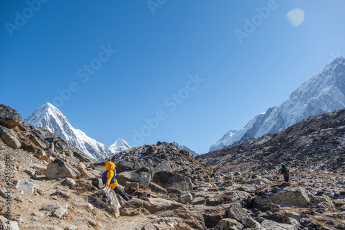 Tourist and porters walking on dirt road in Nepal to Everest Base Camp. Khumbu Glacier, way to Mt Everest base camp, Khumbu valley, Sagarmatha national park, Nepal