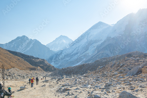 Tourist and porters walking on dirt road in Nepal to Everest Base Camp. Khumbu Glacier, way to Mt Everest base camp, Khumbu valley, Sagarmatha national park, Nepal.