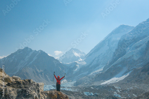 Female backpacker enjoying the view on mountain walk in Himalayas. Everest Base Camp trail route, Nepal trekking, Himalaya tourism.