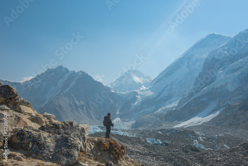 Male backpacker enjoying the view on mountain walk in Himalayas. Everest Base Camp trail route  Nepal trekking  Himalaya tourism.