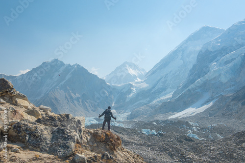 Male backpacker enjoying the view on mountain walk in Himalayas. Everest Base Camp trail route, Nepal trekking, Himalaya tourism.