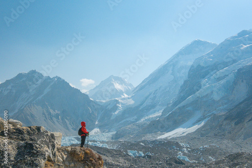 Female backpacker enjoying the view on mountain walk in Himalayas. Everest Base Camp trail route, Nepal trekking, Himalaya tourism. © CravenA