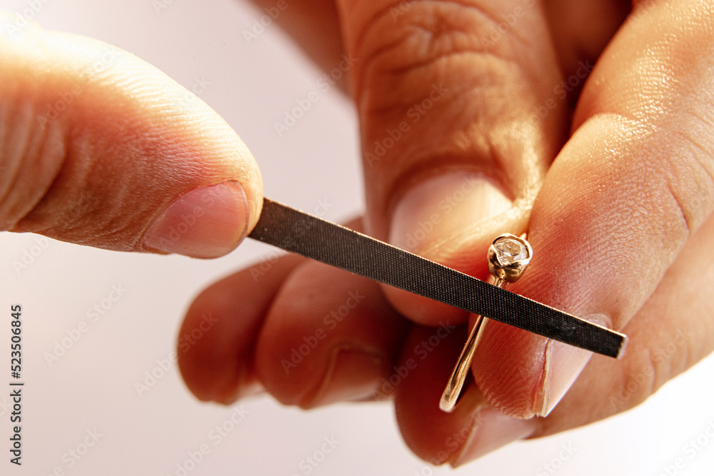 Working process. Closeup hands of jeweler at work in jewelry. Desktop for craft jewelry making with professional tools. Working process. Closeup hands of jeweler at work in jewelry. Desktop for craft jewelry making with professional tools.