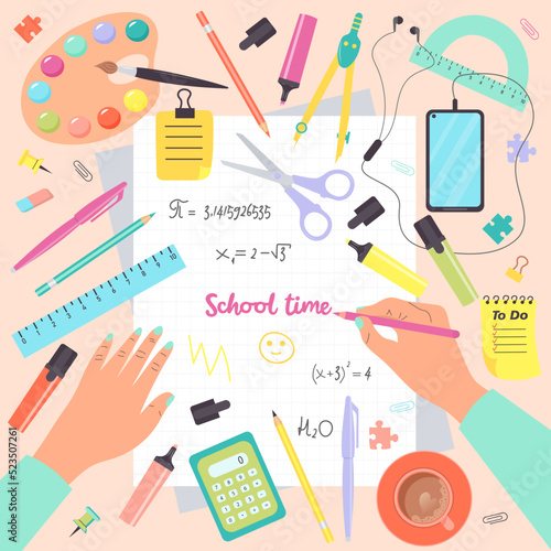 Top view of desk with human hands writing in notebook and school supplies. School time. Colorful set of school objects arranged on a desk from top view.