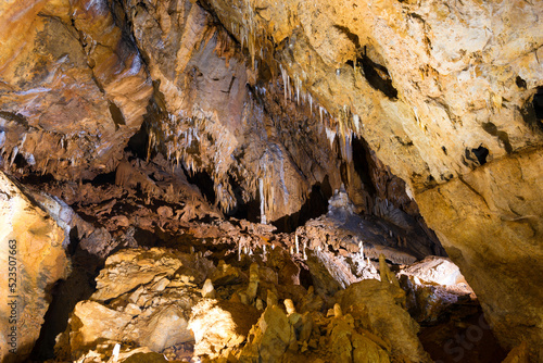 Fototapeta Naklejka Na Ścianę i Meble -  Inside of beautiful old dark cave with many stalactites. Grotte di Is Zuddas, Italy, Sardinia