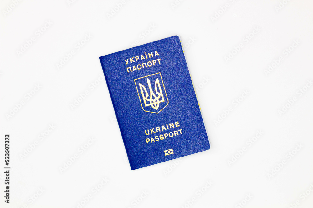 Passport of Ukraine. The cover of the State document of the foreign Ukrainian Passport with the coat of arms of Ukraine on a white background with an electronic chip. Isolated. Image at an angle Passport of Ukraine. The cover of the State document of the foreign Ukrainian Passport with the coat of arms of Ukraine on a white background with an electronic chip. Isolated. Image at an angle