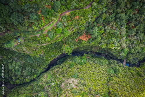 Hiking Levada trail 25 Fontes in Laurel forest - Path to the famous Twenty-Five Fountains in beautiful landscape scenery - Madeira Island, Portugal. October 2021. Aerial drone shot