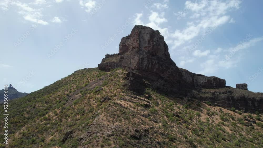 aerial shot in orbit of the Roque Bentayga, seeing the Roque Nublo on the horizon. Take on a sunny day on the Island of Gran Canaria. aerial shot in orbit of the Roque Bentayga, seeing the Roque Nublo on the horizon. Take on a sunny day on the Island of Gran Canaria.
