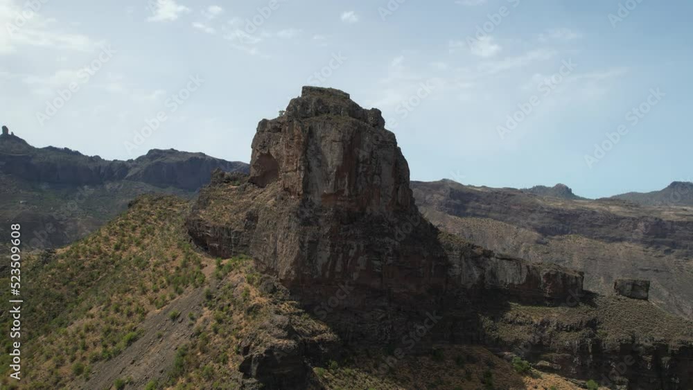 fantastic aerial shot in half orbit of the Roque Bentayga. Taken on a sunny day. It belongs to one of the magical forms of Gran Canaria: the giant's shoe. fantastic aerial shot in half orbit of the Roque Bentayga. Taken on a sunny day. It belongs to one of the magical forms of Gran Canaria: the giant's shoe.