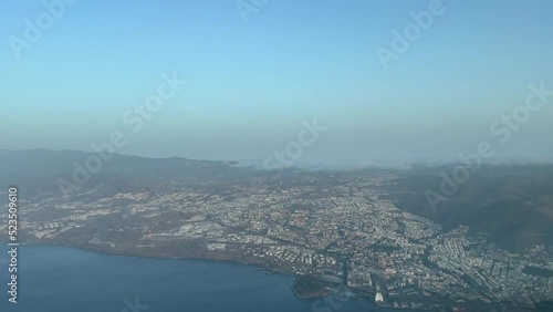 Aerial view from a jet cockpit of Santa Cruz of Tenerife city during the approach to Los Rodeos airport, early in the moorning in a summer and hot day. Pilot POV photo