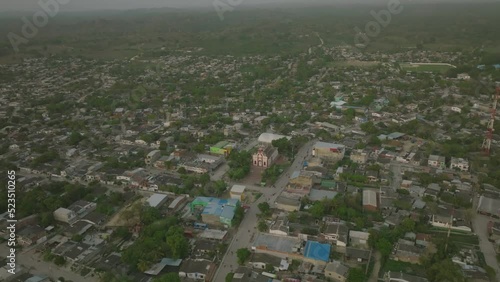 Wide aerial footage that is pulling away from Iglesia De Santa Rosa De Lima in Santa Rosa, Colombia during sunset. photo