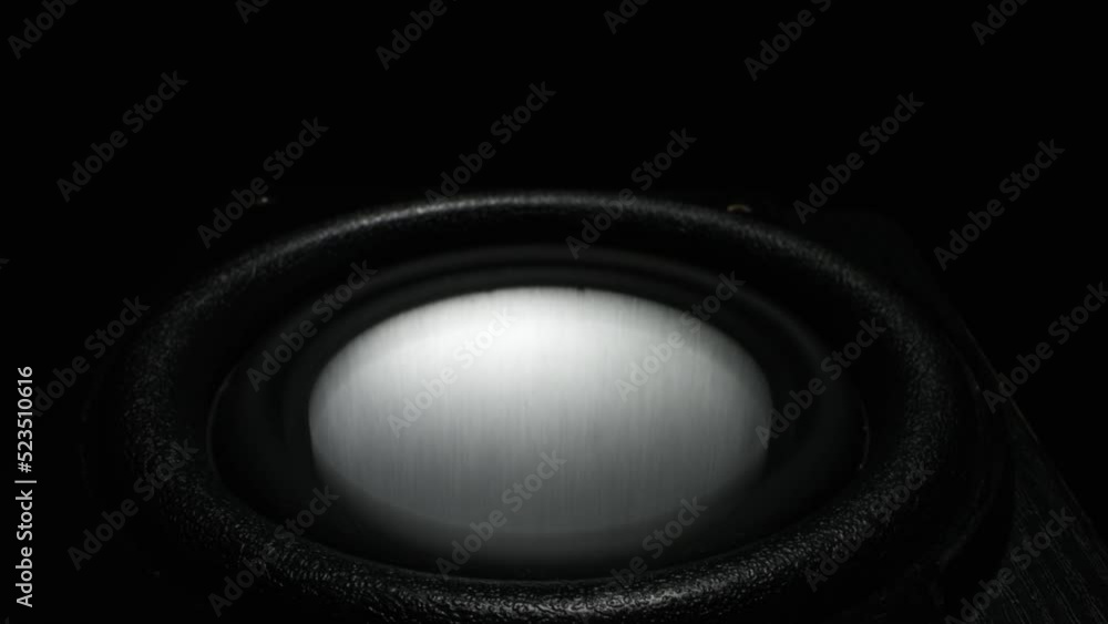 Bass sound speaker closeup. Vibrations of low bass. Black bass woofer