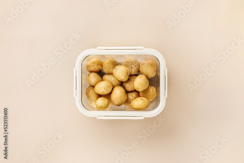 Glass box with fresh raw potatoes.  Vegetables in a glass containers. Food storage concept