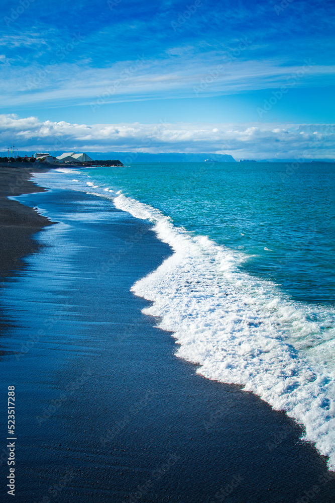 Stunning views of mighty ocean breakers over black sand beach in Napier