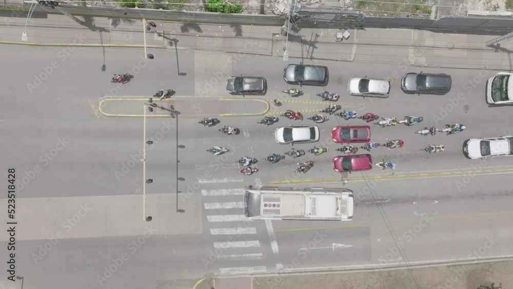 Aerial top down of traffic at a red light and then moving when it changes to green in Cartagena, Colombia. Aerial top down of traffic at a red light and then moving when it changes to green in Cartagena, Colombia.