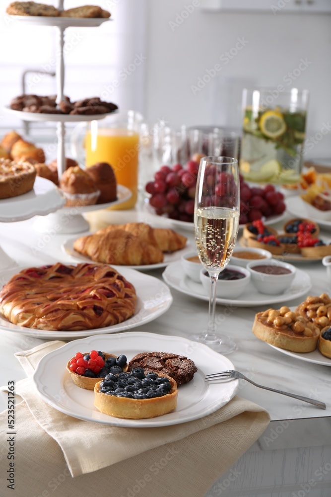 Variety of snacks on white marble table in buffet style indoors Variety of snacks on white marble table in buffet style indoors