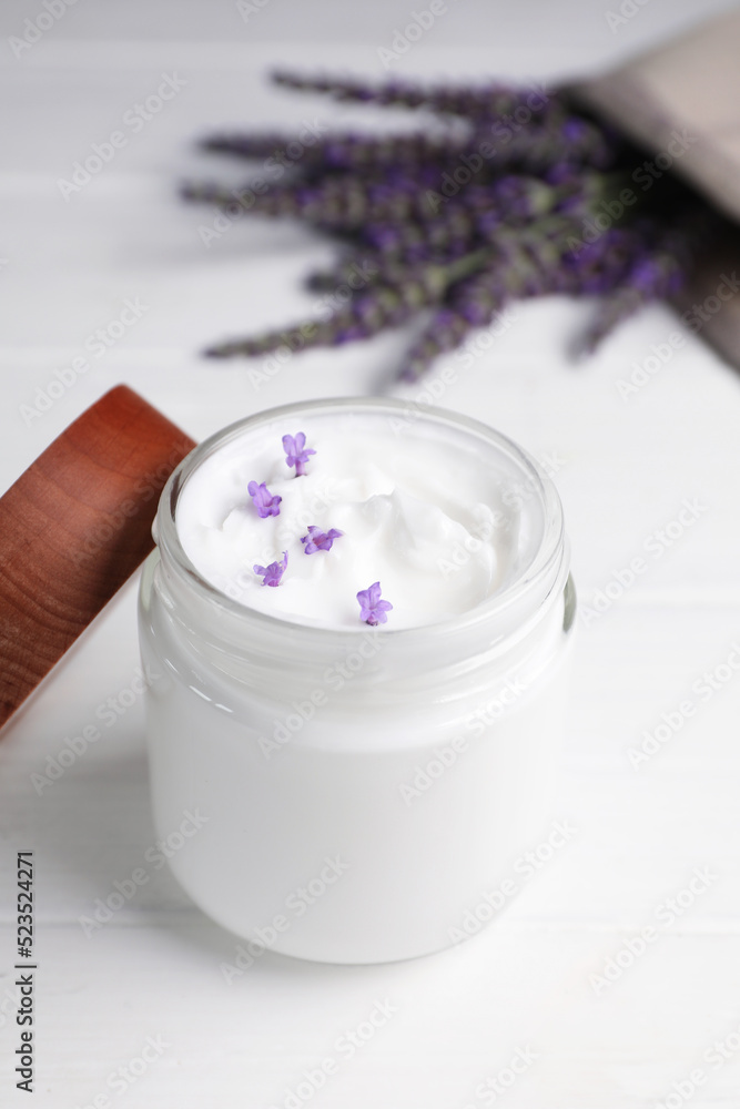Jar of face cream and beautiful lavender on white wooden table Jar of face cream and beautiful lavender on white wooden table