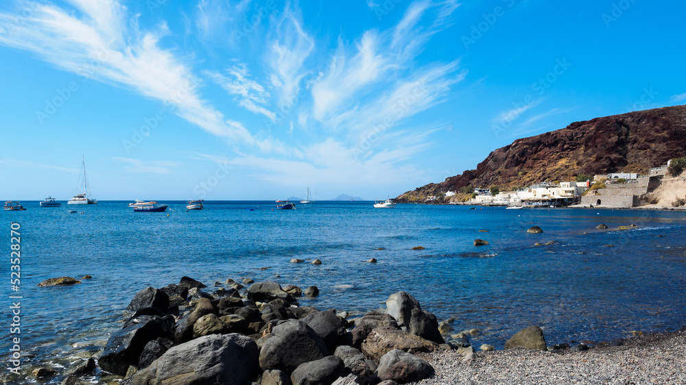 Calm sea bay with anchored boats, yachts and rocky shores