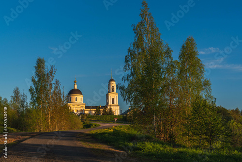Beautiful summer landscape with a church at sunset