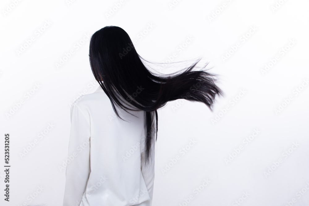 Foto de Black Straight Long Black Hair woman throw fly in air with fashion  stylish and fun joy. Female turn back wear white shirt express emotion  happy by blow wind hair, isolated